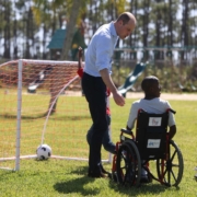 prince william with a young boy in a wheelchair